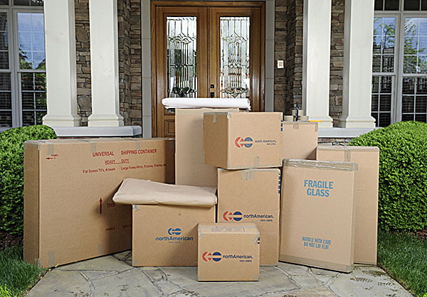 moving boxes stacked in front of house